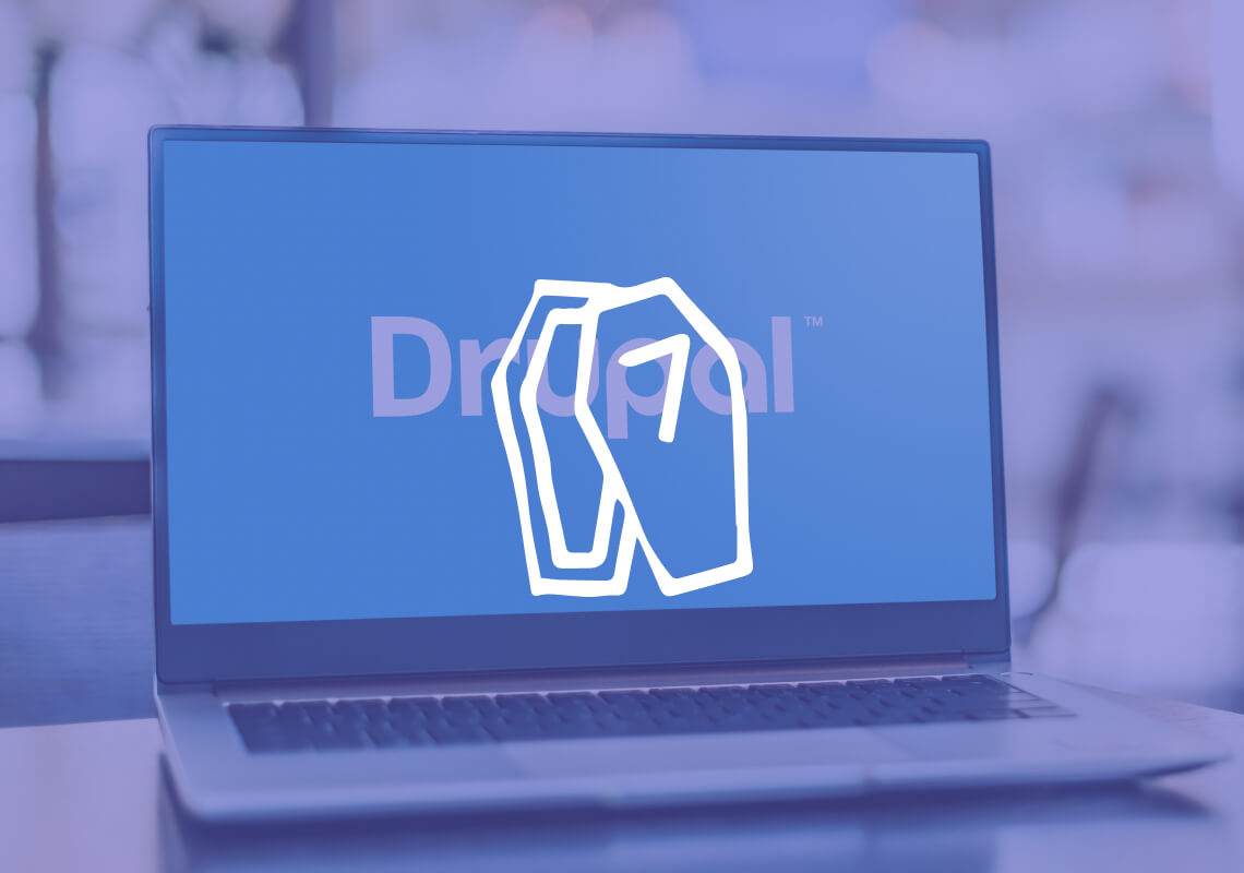 Laptop displaying the Drupal logo on the screen.