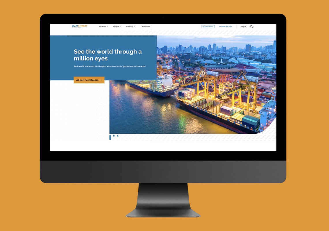 Computer screen displaying a port logistics website with container ships.