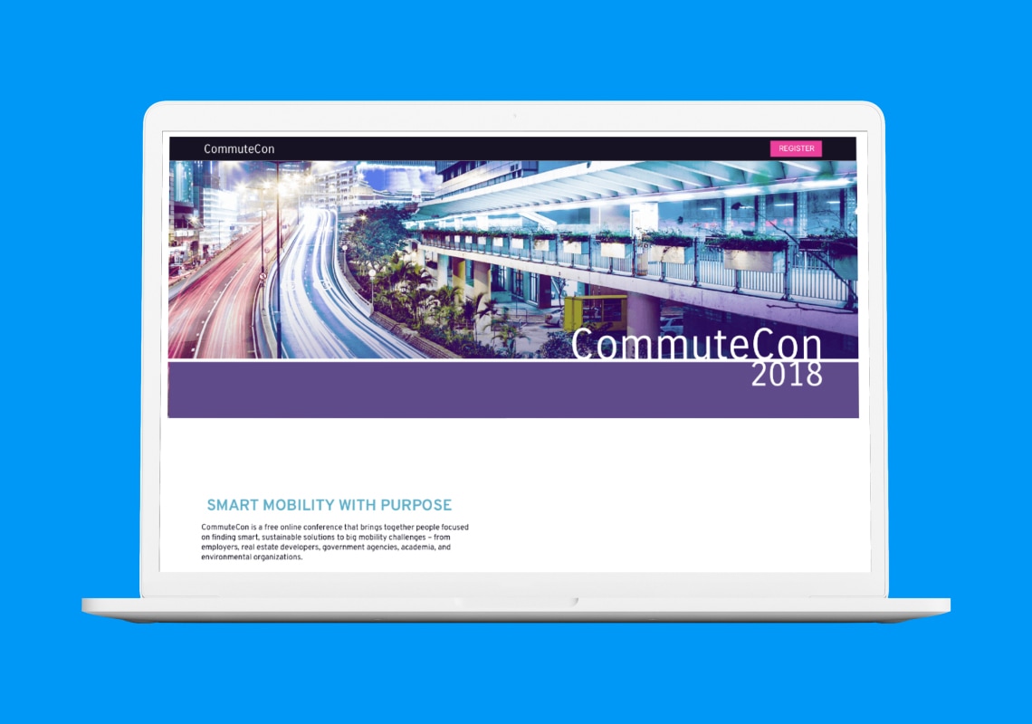 Laptop displaying the CommuteCon 2018 conference page with a cityscape background.