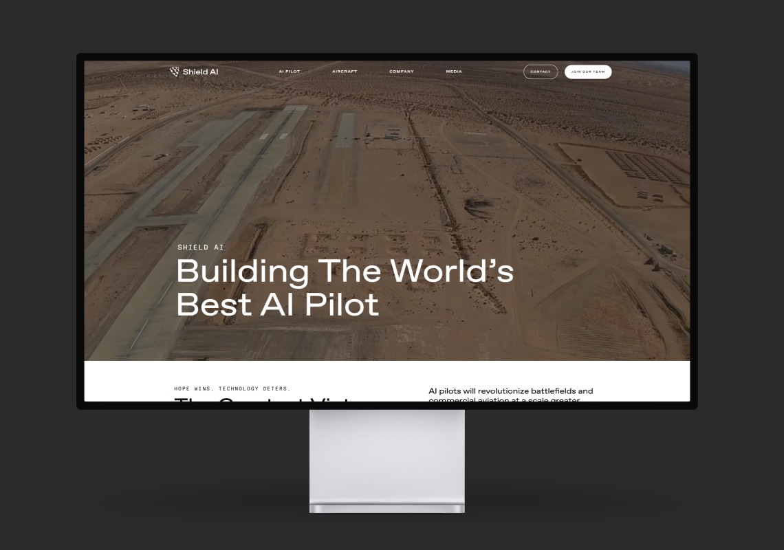 Computer monitor displaying Shield AI webpage about AI pilots.