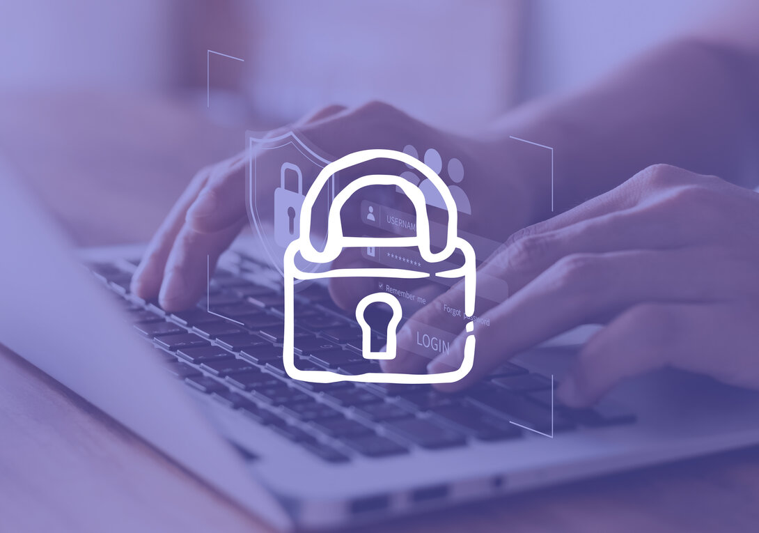 Hands typing on laptop keyboard with digital lock overlay symbolizing cybersecurity.