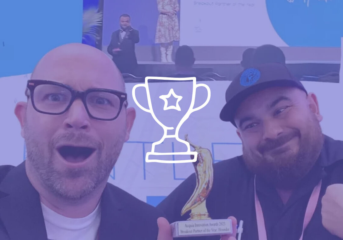 Two excited men holding a trophy at an awards event.