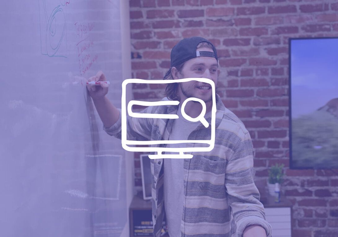Person writing on a whiteboard with a search icon overlay.