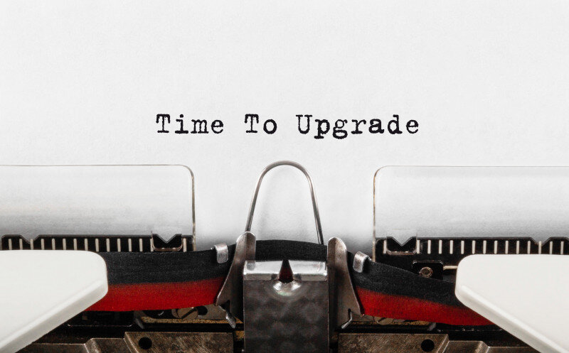 "Typewriter typing 'Time To Upgrade' on paper."