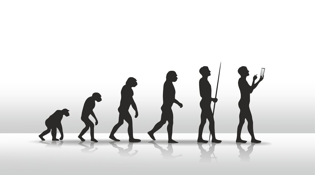Evolution of humans from apes to technology users in silhouette.