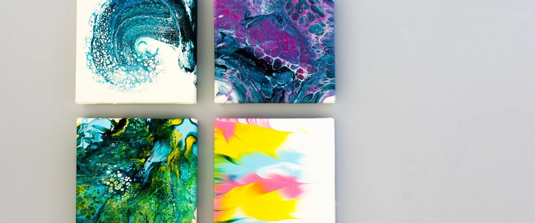 Four colorful abstract paintings with vibrant patterns on a grey background.