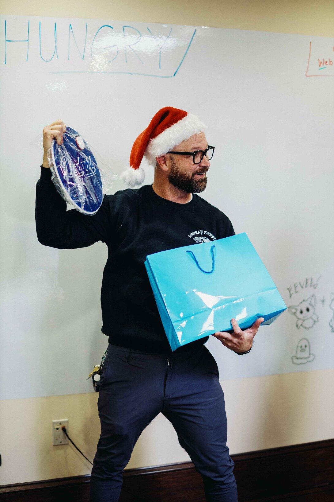 hounder founder opening secret santa gift