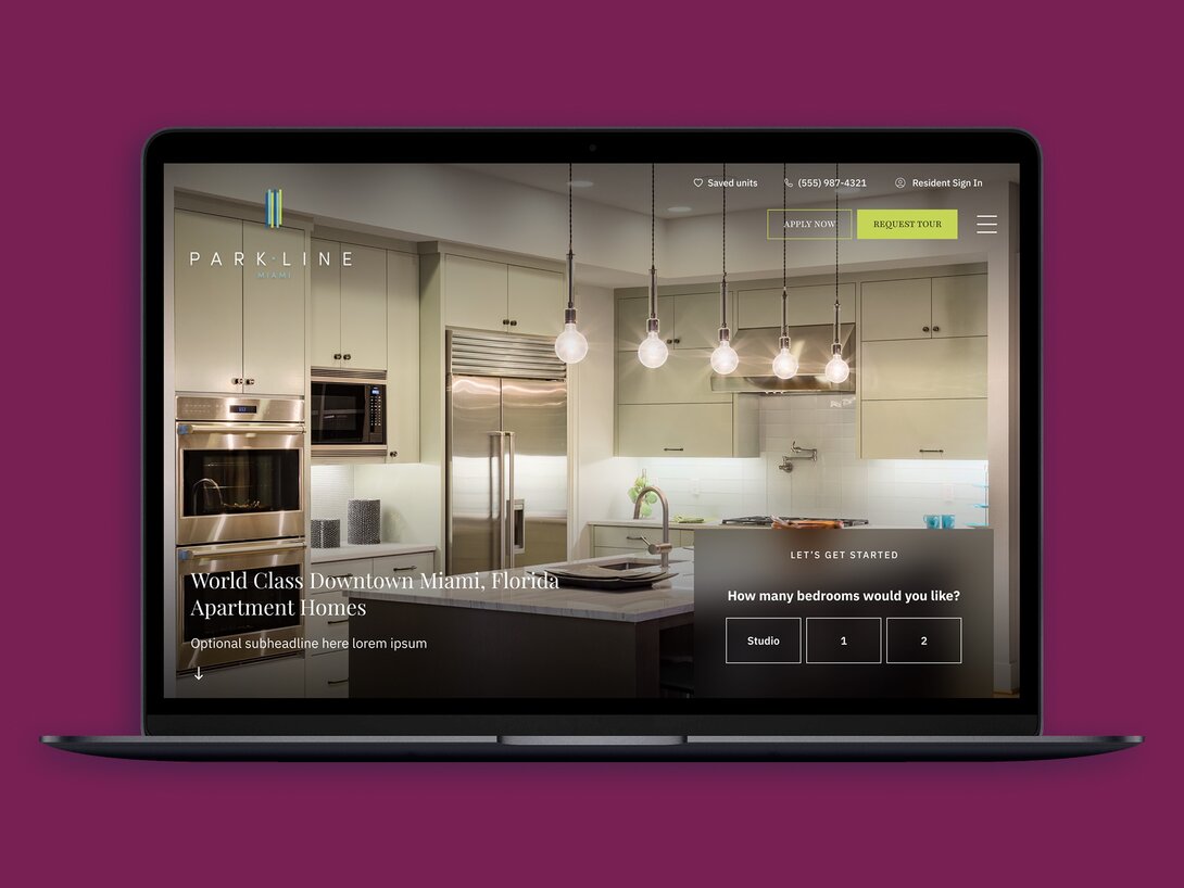 Laptop displaying a luxury Miami apartment kitchen, website interface visible.