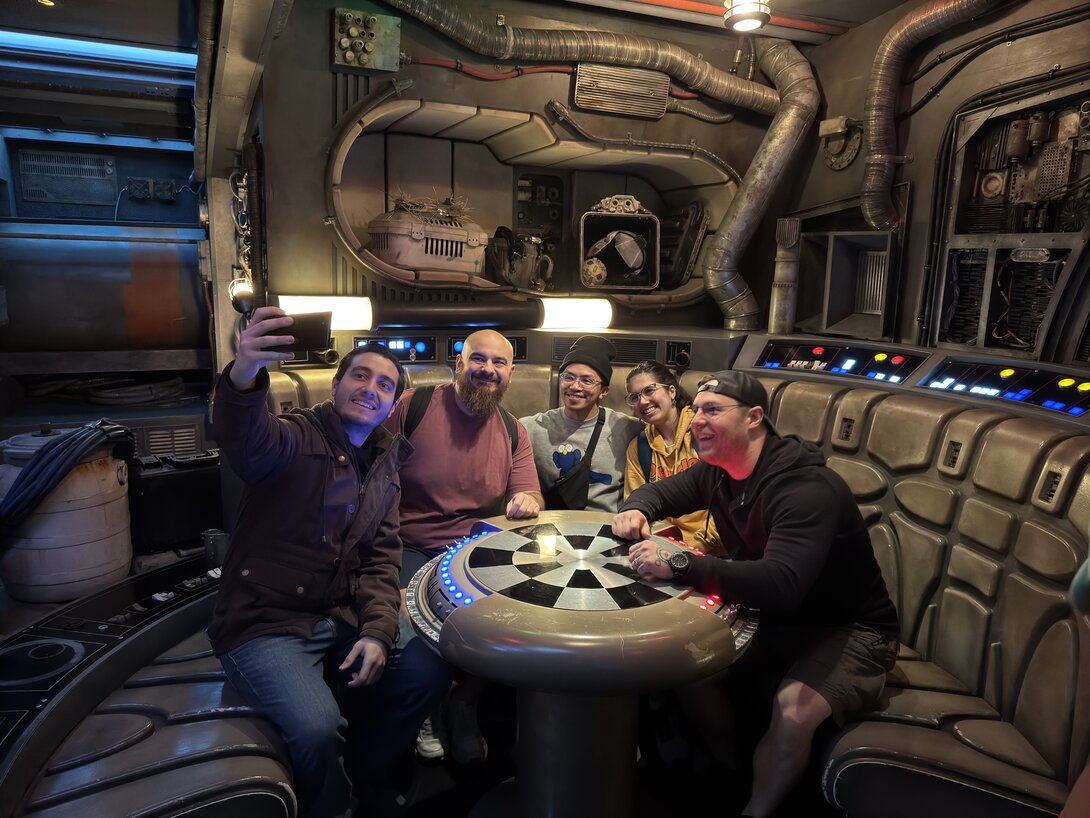Group taking selfie inside a sci-fi themed room with futuristic decor.