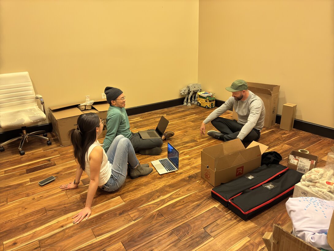 three hounder team members sitting on floor during marketing meeting