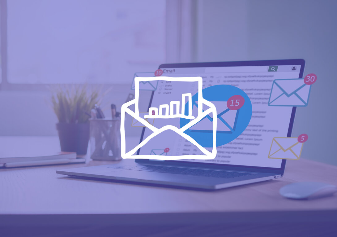 Laptop on desk with email notifications and graph overlay.